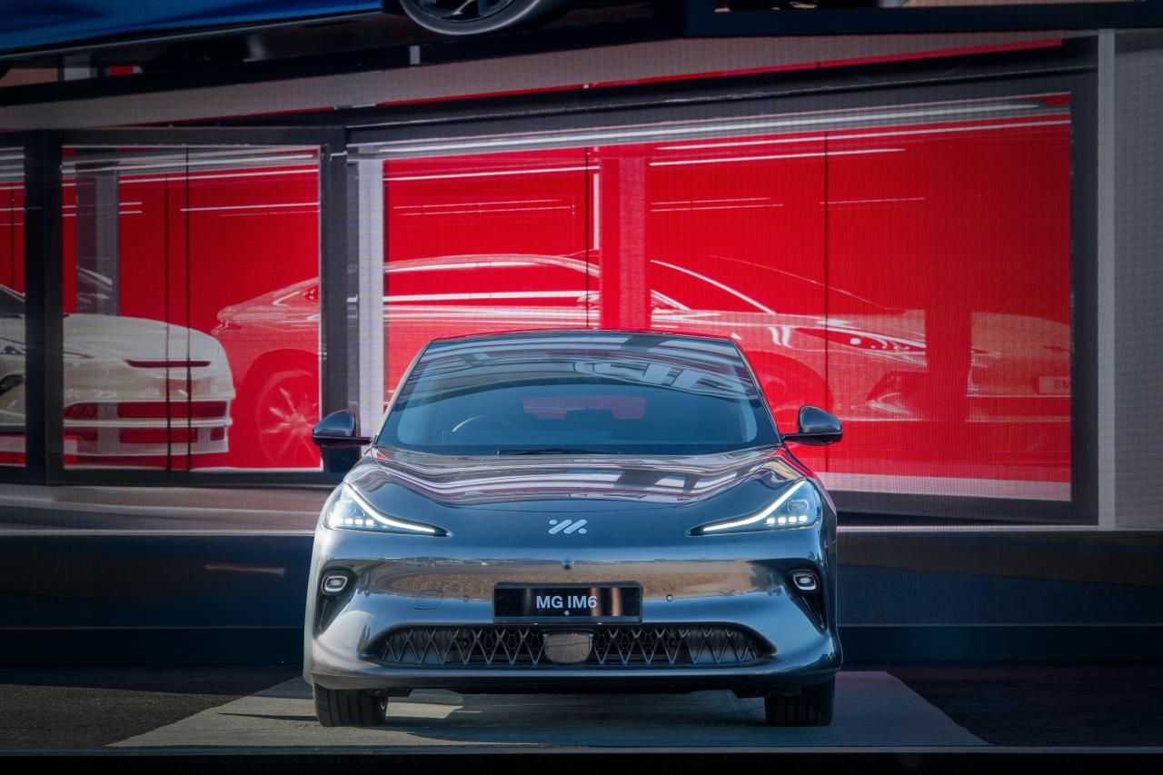 A sleek car is parked in front of a showroom.